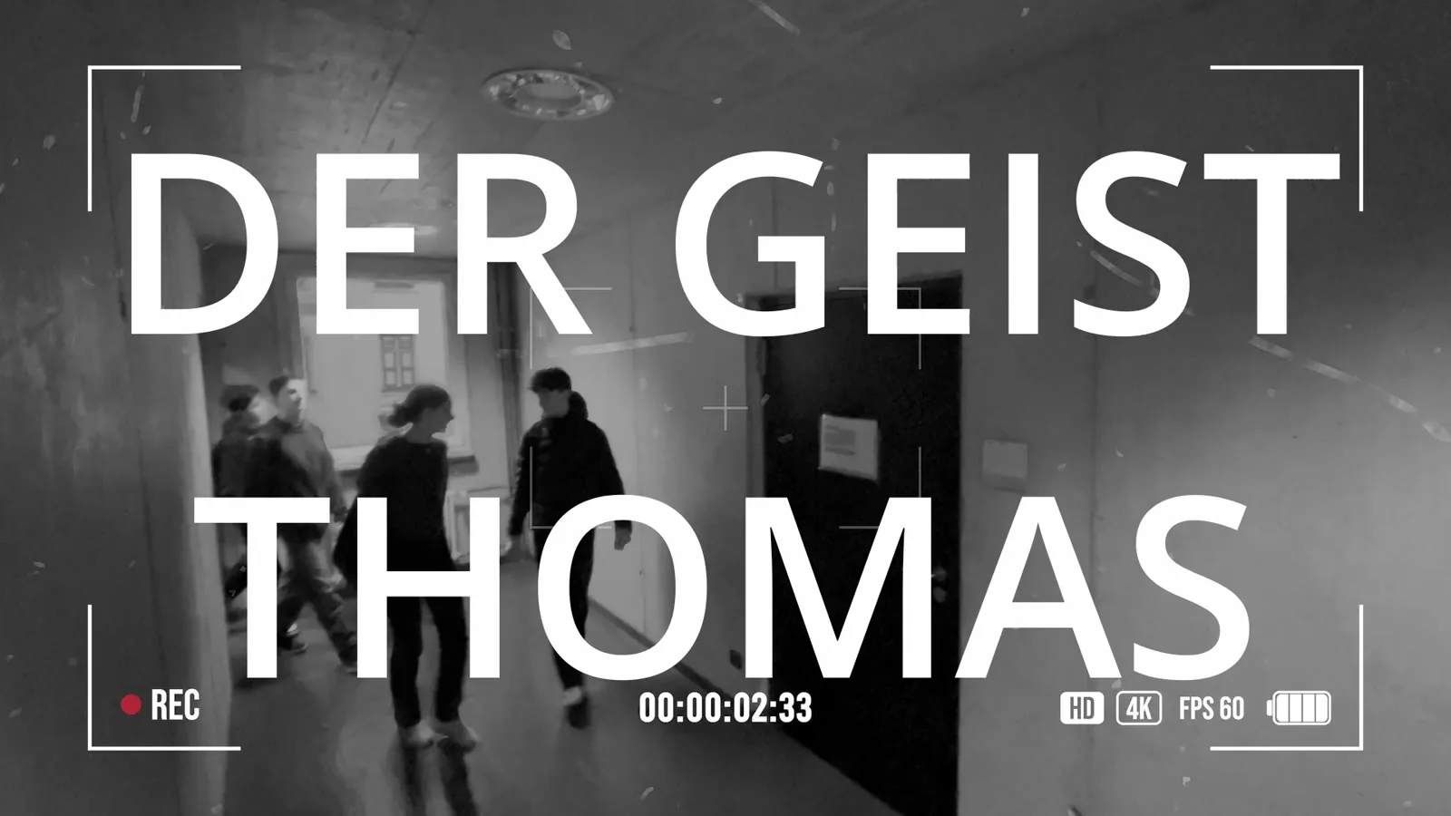 Title card for Der Geist Thomas over a black-and-white school hallway scene