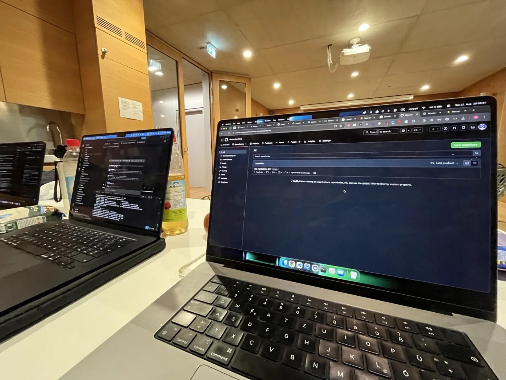 Laptops open on a table at studiTUM during the Reframe hackathon
